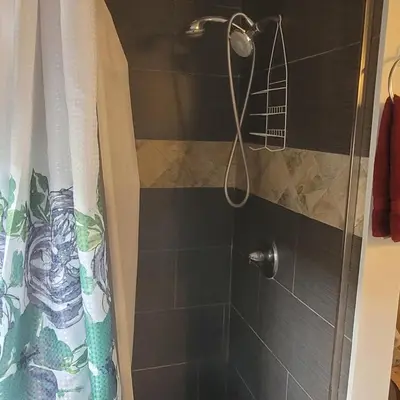 a shower with a shower head in a bathroom at LA Getaway Oasis in Los Angeles
