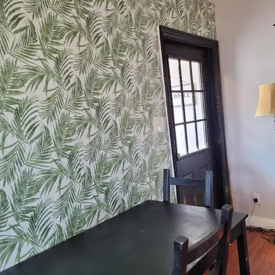 a dining room with a table and a wall at LA Getaway Oasis in Los Angeles