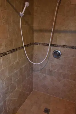 a shower with a hose in a bathroom at LA Getaway Oasis in Los Angeles