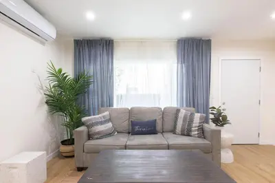 a living room with a couch and a large window at Stylish Long Beach Retreat Walk to Beach Bars in Long Beach