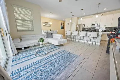 a living room and kitchen with white furniture and a rug at LBL4837 in Los Angeles