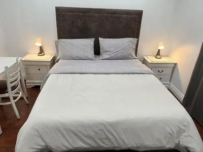 a bedroom with a large bed with two night stands at \u5b89\u9759\u6574\u6d01\u4fbf\u6377\u7684\u72ec\u7acb\u623f\u5b50 in Baldwin Park