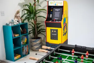 a lego bowling alley with a video game machine at Stunning secluded Creekside A-Frame gameroom in Lake Arrowhead