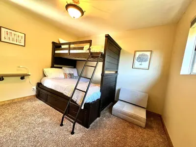a bedroom with a bunk bed and a ladder at Stunning secluded Creekside A-Frame gameroom in Lake Arrowhead