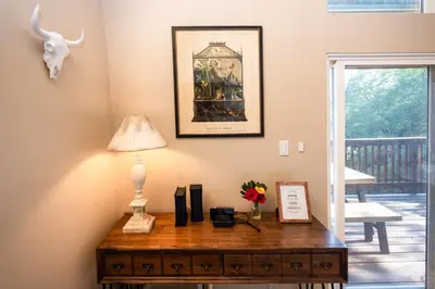 a desk with a lamp and a picture on the wall at Stunning secluded Creekside A-Frame gameroom in Lake Arrowhead