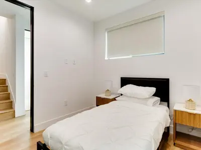 a white bedroom with a large bed and a window at Modern Luxe Retreat Four-Bedroom in Los Angeles