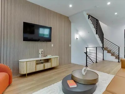 a living room with a tv on a wall at Modern Luxe Retreat Four-Bedroom in Los Angeles