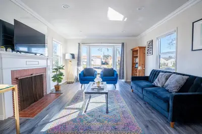 a living room with a blue couch and a fireplace at Comfy Home Near Sofi Stadium in Los Angeles
