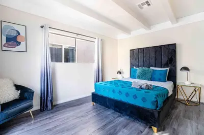 a bedroom with a blue bed and a window at Comfy Home Near Sofi Stadium in Los Angeles