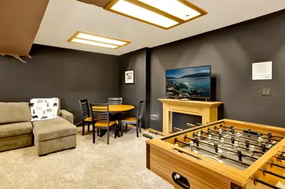a living room with a table and a large game board at The Birdhouse at Big Bear Lake- Lakeview Family Retreat in Big Bear Lake
