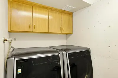 a kitchen with a microwave and wooden cabinets at The Birdhouse at Big Bear Lake- Lakeview Family Retreat in Big Bear Lake