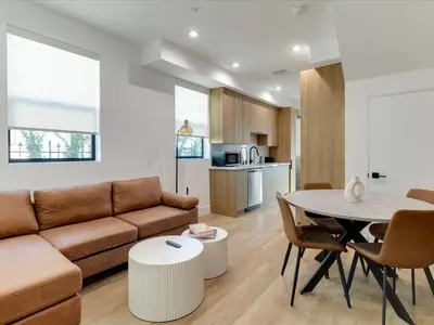 a living room with a couch and a table at Modern Luxe Retreat Two-Bedroom in Los Angeles