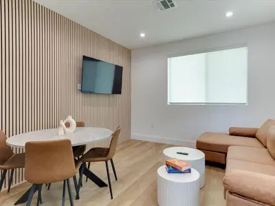 a living room with a table and a couch at Modern Luxe Retreat Two-Bedroom in Los Angeles