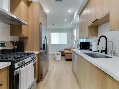 a kitchen with a sink and a stove top oven at Modern Luxe Retreat Two-Bedroom in Los Angeles