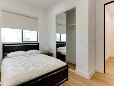 a bedroom with a large bed and a mirror at Modern Luxe Retreat Six-Bedroom in Los Angeles