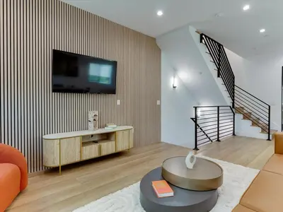 a living room with a tv on a wall at Modern Luxe Retreat Six-Bedroom in Los Angeles
