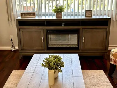 a living room with a table with a fireplace at Cactus Casino with game room next to Yaamava Casino in Highland