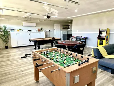 a living room with a foos ball and a pool table at Cactus Casino with game room next to Yaamava Casino in Highland