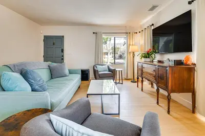a living room with a couch and a tv at 1 Mi to Rose Bowl! Updated Home with Furnished Deck in Pasadena