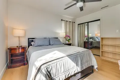 a bedroom with a large bed with a ceiling fan at 1 Mi to Rose Bowl! Updated Home with Furnished Deck in Pasadena