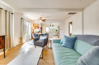a living room with a couch and a table at 1 Mi to Rose Bowl! Updated Home with Furnished Deck in Pasadena