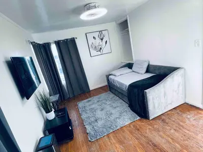 a room with a bed and a tv in it at Beautiful private upstairs studio - USC, LAX, SOFI in Los Angeles