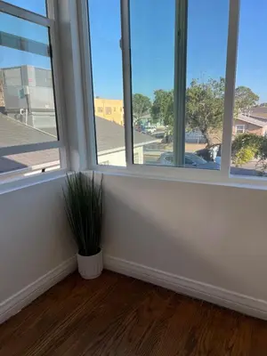 a room with two windows and a potted plant at Beautiful private upstairs studio - USC, LAX, SOFI in Los Angeles
