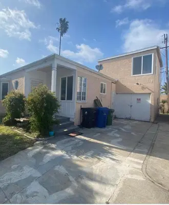 a house with a palm tree in front of it at Beautiful private upstairs studio - USC, LAX, SOFI in Los Angeles