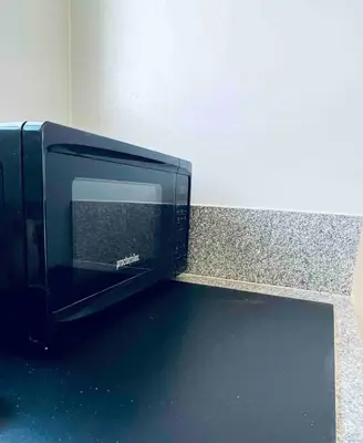 a microwave oven sitting on top of a counter at Beautiful private upstairs studio - USC, LAX, SOFI in Los Angeles
