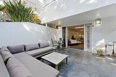 a living room with a couch and a table at The Hidden Hideaway in Summerland