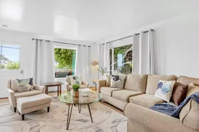 a living room with a couch and a table at Summerland Beach Oasis- Pet Friendly in Summerland