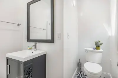 a bathroom with a white toilet and a mirror at Gillians Room- Pet Friendly in Summerland