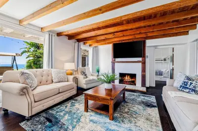 a living room with a couch and a fireplace at The Grand Escape - Casita Sonrisa in Summerland