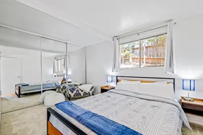 a bedroom with a large bed and a window at The Grand Escape - Casita Sonrisa in Summerland