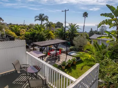 a balcony with a table and chairs and the ocean at The Grand Escape - Casita Sonrisa in Summerland