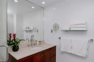 a white bathroom with a sink and a mirror at On Sunset Blvd - 5 star retreat in Los Angeles