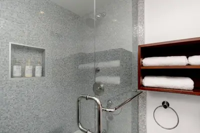 a shower with a glass door in a bathroom at On Sunset Blvd - 5 star retreat in Los Angeles