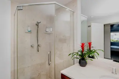 a bathroom with a shower with a plant on a counter at On Sunset Blvd - 5 star retreat in Los Angeles