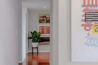 a hallway with a bench and a potted plant at On Sunset Blvd - 5 star retreat in Los Angeles