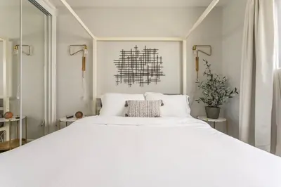 a bedroom with a large white bed with white pillows at 3BR Townhouse in Prime Manhattan Beach Location in Manhattan Beach