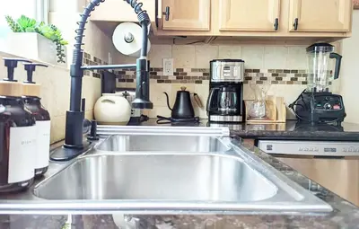 a kitchen counter with a sink in a kitchen at Seaside Sanctuary - Rooftop Deck & Hot Tub in Hermosa Beach