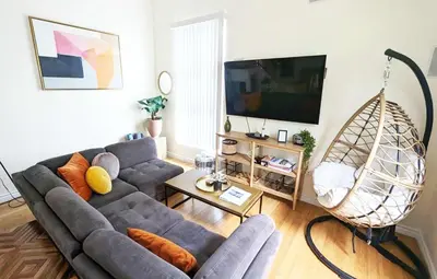 a living room with a couch and a swing at Seaside Sanctuary - Rooftop Deck & Hot Tub in Hermosa Beach
