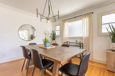 a dining room with a wooden table and chairs at Charming 1920s Hermosa Bungalow Steps from The Strand in Hermosa Beach