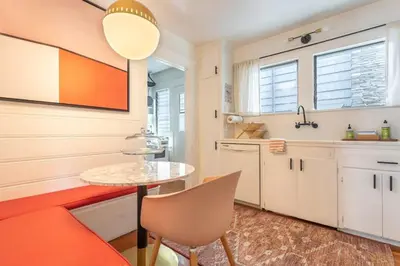a kitchen with a small table and a table at Charming 1920s Hermosa Bungalow Steps from The Strand in Hermosa Beach