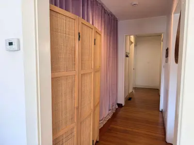 a hallway with wooden doors in a room with wood floors at Charming 1920s Hermosa Bungalow Steps from The Strand in Hermosa Beach