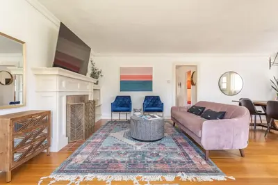 a living room with a couch and a fireplace at Charming 1920s Hermosa Bungalow Steps from The Strand in Hermosa Beach
