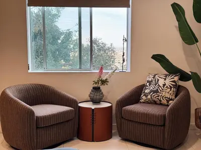 two chairs and a table in a room with a window at Hollywood hill stunning view cozy private room in Los Angeles