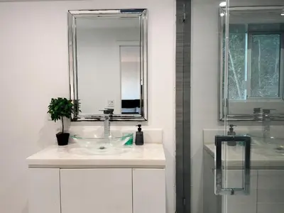 a bathroom with a sink and a mirror at Hollywood hill stunning view cozy private room in Los Angeles
