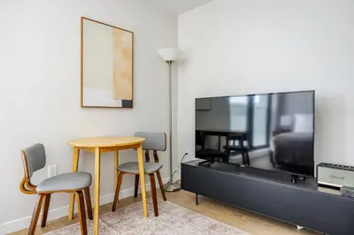 a living room with a tv and a table and chairs at Blueground Downtown elevator nr parks LAX-1245 in Los Angeles