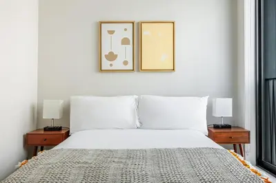 a bedroom with a white bed and two lamps at Blueground Downtown elevator nr parks LAX-1245 in Los Angeles
